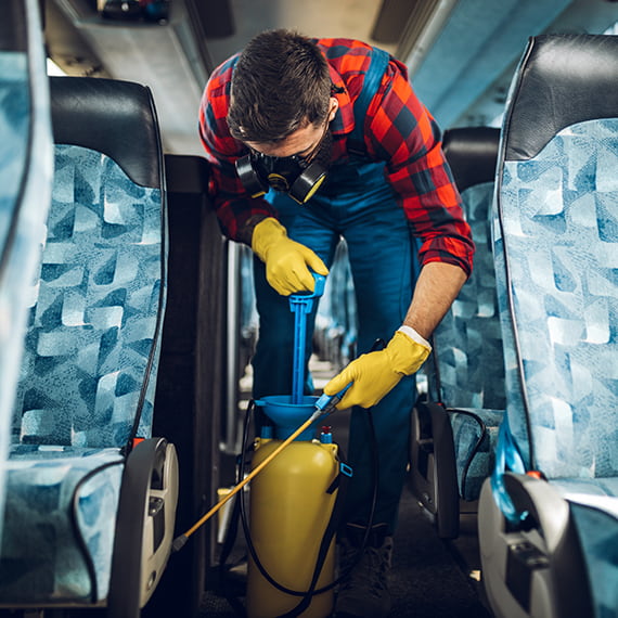 a man cleans the interior of a charter bus